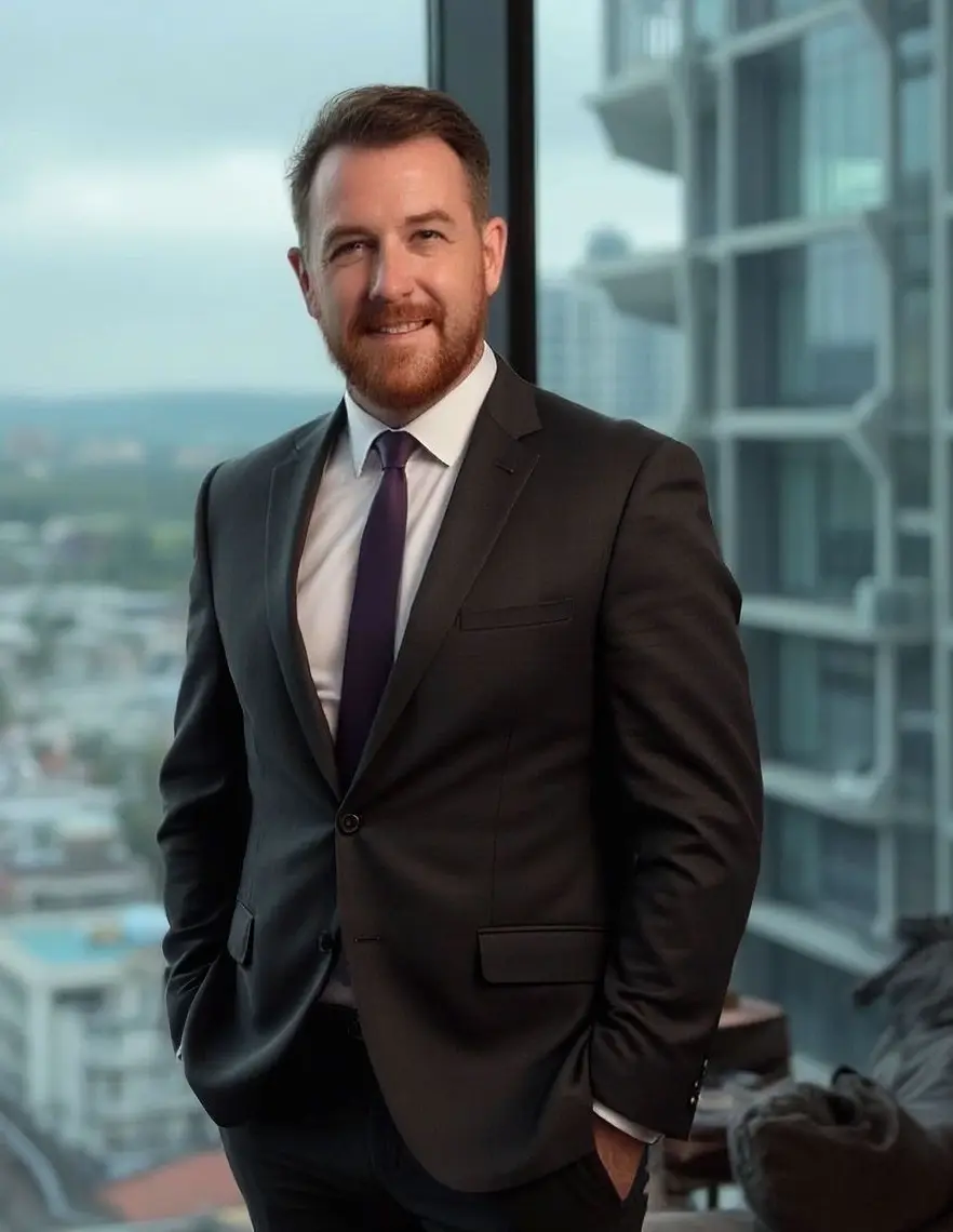 Mark Clulow Mark Clulow, an early middle-aged man stands next to a window overlooking a city . He is wearing a dark business suit, white shirt and black tie. He appears happy and friendly.